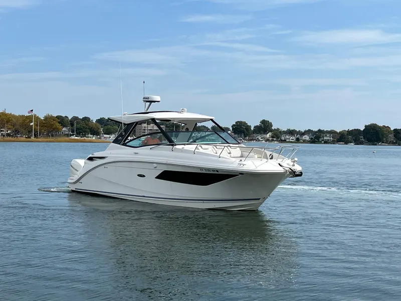 Slide: The Image of 2022 Sea Ray Sundancer 320 OB cruising on calm waters. - 4