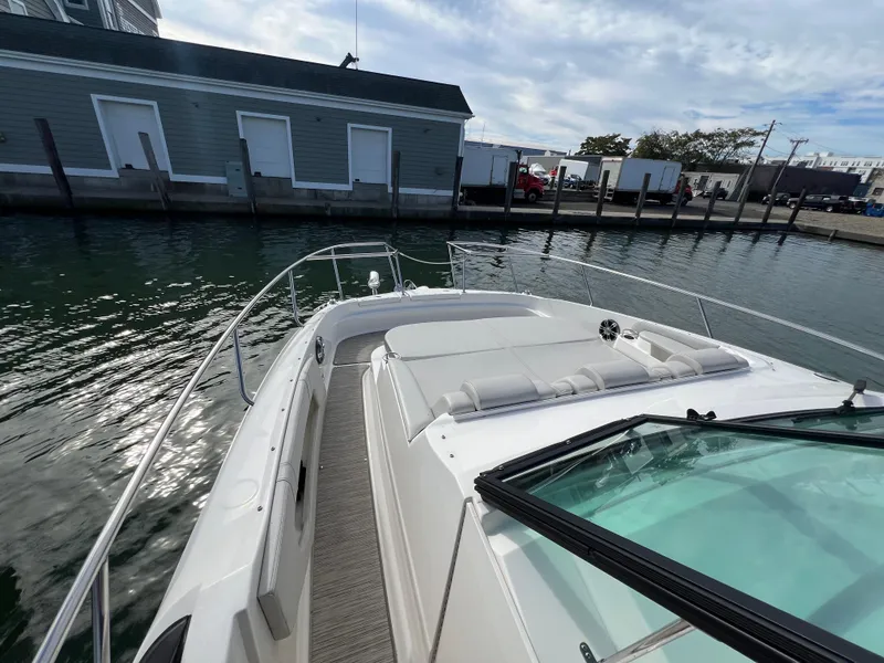 Slide: The Image of 2022 Sea Ray Sundancer 320 OB docked, showcasing sleek design and spacious deck. - 40