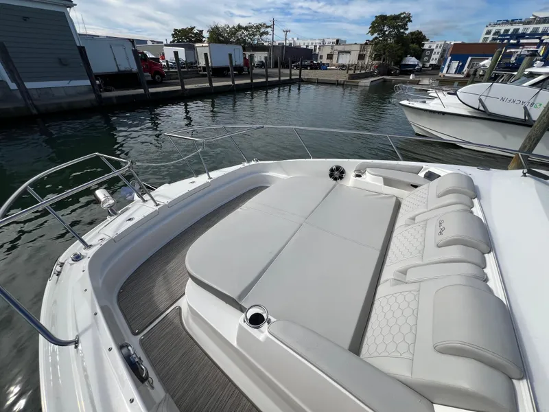 Slide: The Image of 2022 Sea Ray Sundancer 320 OB boat with spacious deck seating in marina. - 41