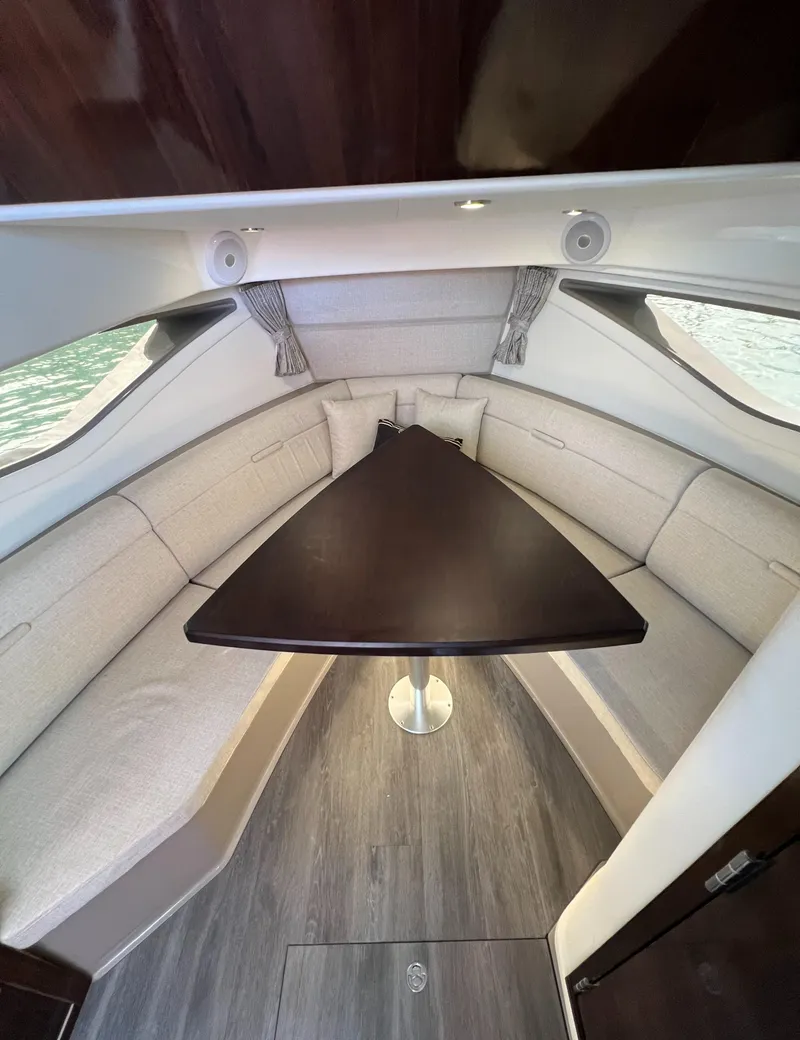 Slide: The Image of 2022 Sea Ray Sundancer 320 OB cabin with elegant seating and triangular table. - 46