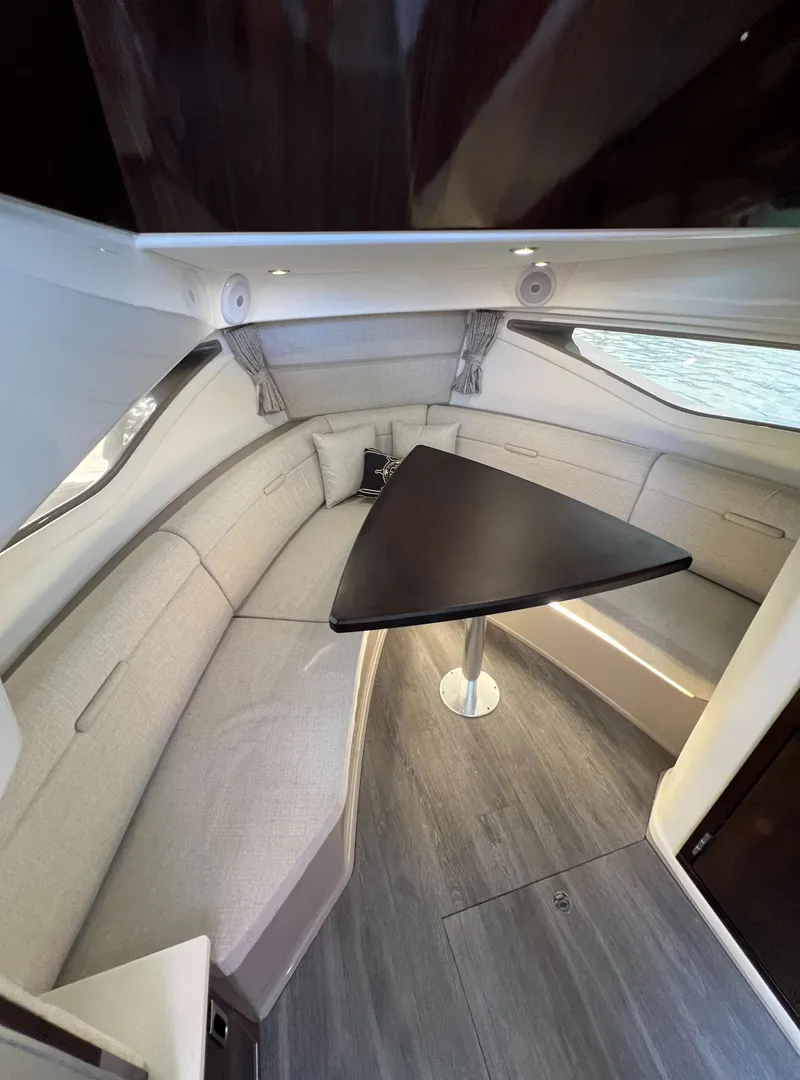 Slide: The Image of Interior of 2022 Sea Ray Sundancer 320 OB with modern seating and triangular table. - 47