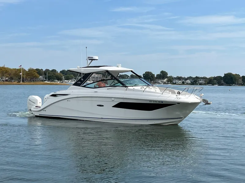 Slide: The Image of 2022 Sea Ray Sundancer 320 OB cruising on calm waters. - 5
