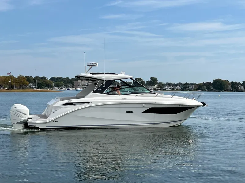 Slide: The Image of 2022 Sea Ray Sundancer 320 OB cruising on calm waters. - 6