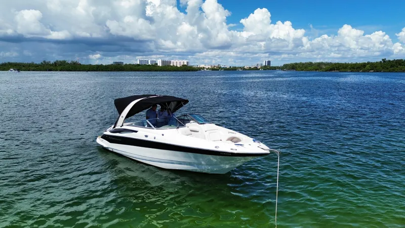 The Image of 2008 Crownline 300 LS boat on calm water under a blue sky. - 0