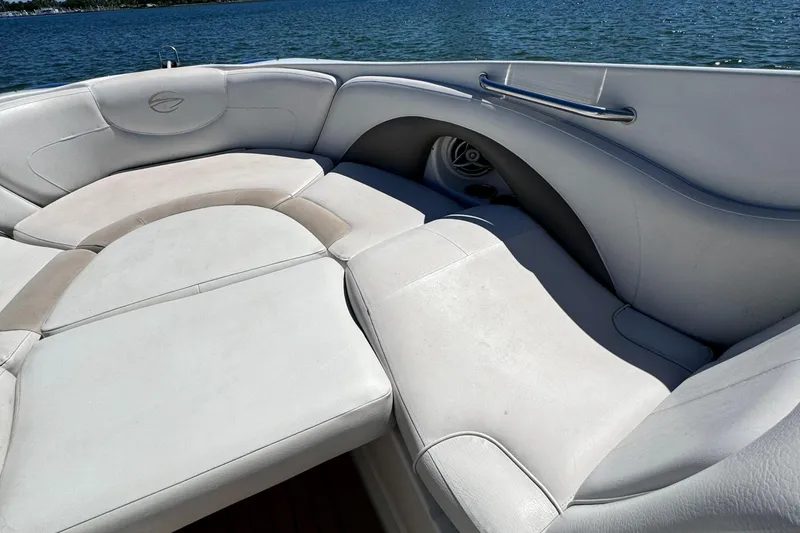 Slide: The Image of 2008 Crownline 300 LS boat interior with white cushioned seating, on a sunny day. - 10