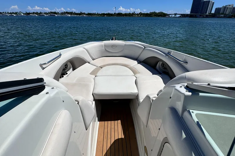 Slide: The Image of 2008 Crownline 300 LS boat interior with white seating on a sunny day. - 11
