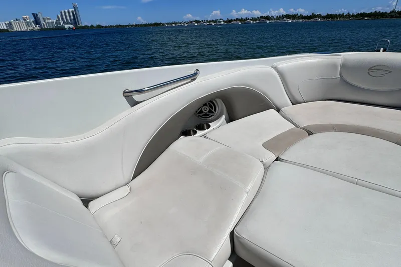 Slide: The Image of 2008 Crownline 300 LS boat interior with white seating, ocean view, and city skyline. - 12