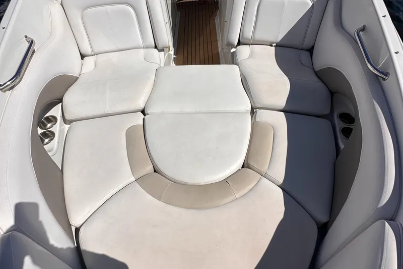 Slide: The Image of 2008 Crownline 300 LS boat interior with white cushioned seating. - 17