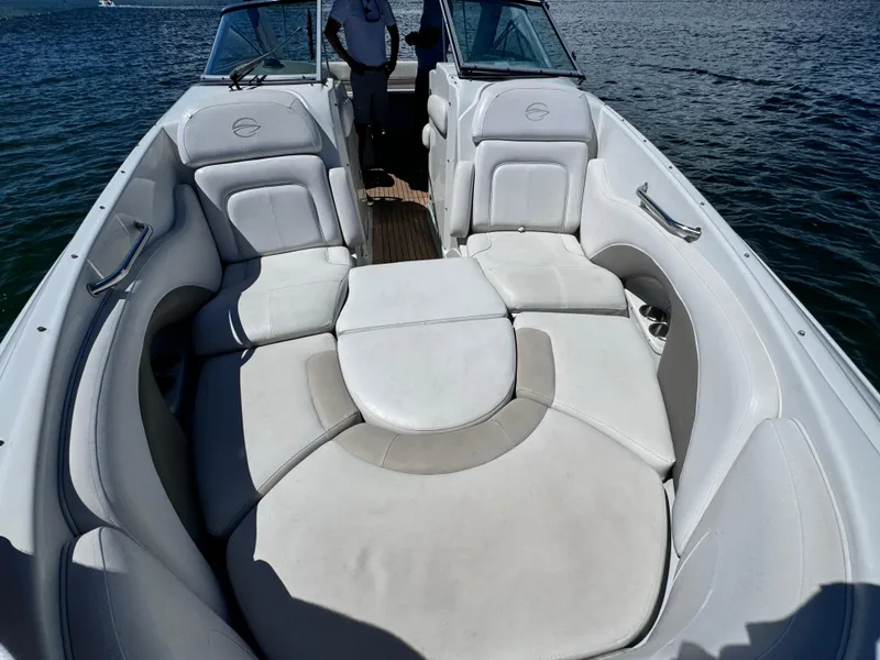 Slide: The Image of 2008 Crownline 300 LS boat interior with white seating on water. - 18