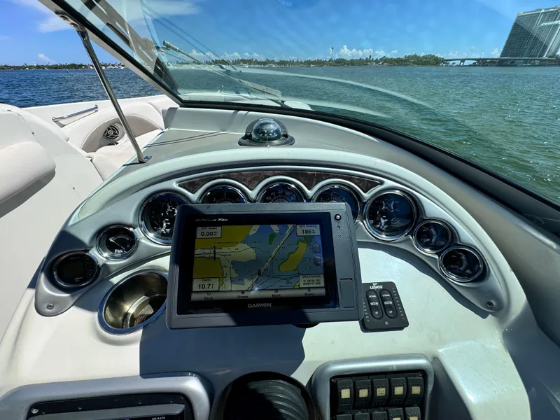 Slide: The Image of Crownline 300 LS 2008 boat dashboard with GPS navigation on a sunny day. - 20