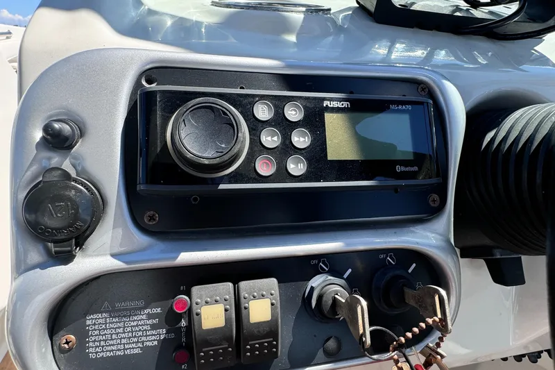 Slide: The Image of Control panel of a 2008 Crownline 300 LS boat with Fusion stereo system. - 23
