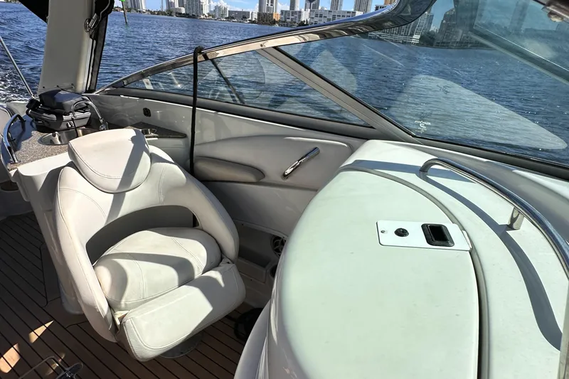 Slide: The Image of 2008 Crownline 300 LS boat interior with white seating and waterfront view. - 26