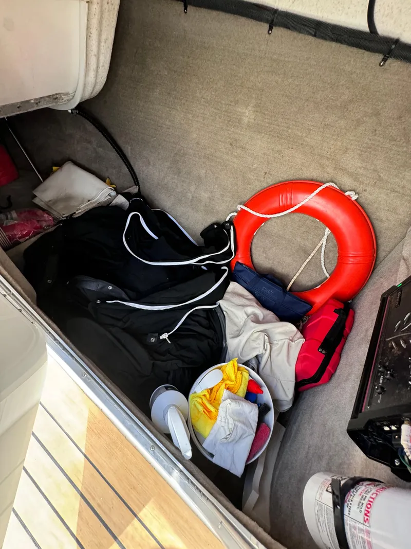 Slide: The Image of Storage compartment in 2008 Crownline 300 LS boat with life preserver and gear. - 27