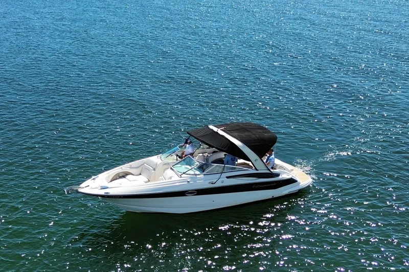 Slide: The Image of 2008 Crownline 300 LS boat cruising on clear blue water. - 3