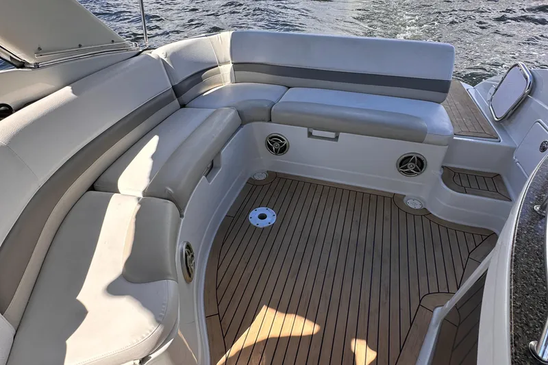 Slide: The Image of 2008 Crownline 300 LS boat interior with cushioned seating and wooden flooring. - 32