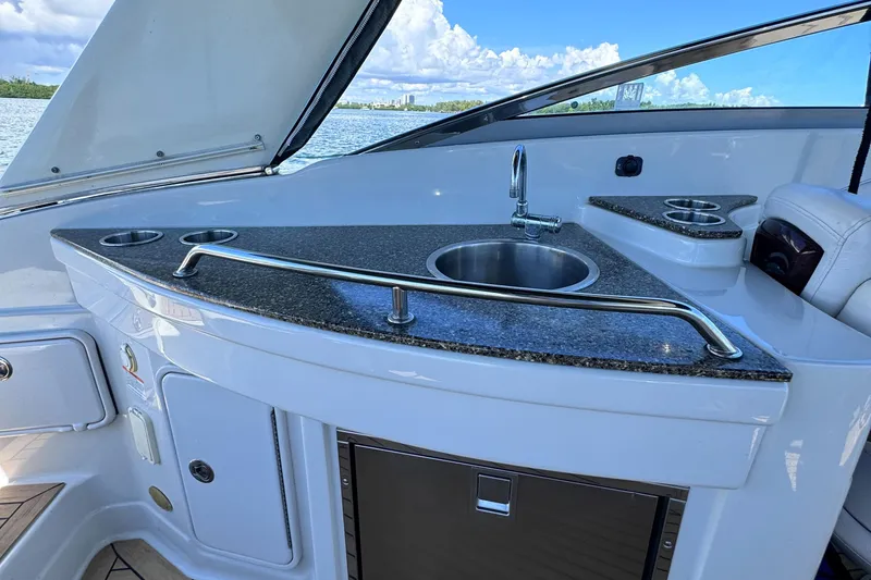 Slide: The Image of 2008 Crownline 300 LS boat interior with sleek kitchenette and sink. - 33