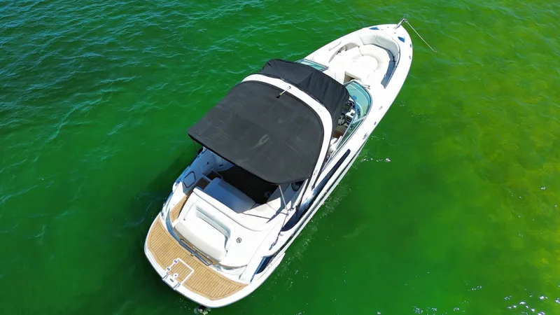 Slide: The Image of 2008 Crownline 300 LS boat on vibrant green water, aerial view. - 5