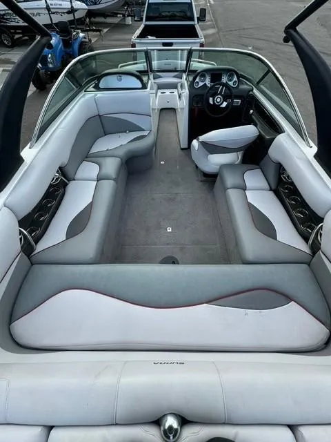 Slide: The Image of 2011 Supra 22v boat interior with gray and white seating, sleek design. - 10