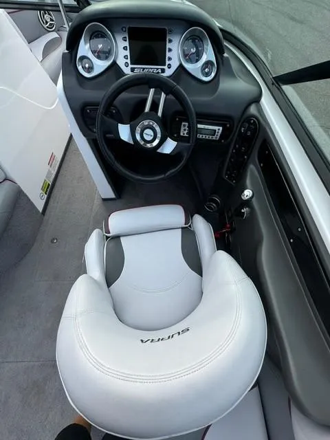 Slide: The Image of 2011 Supra 22v boat interior with steering wheel and dashboard. - 13