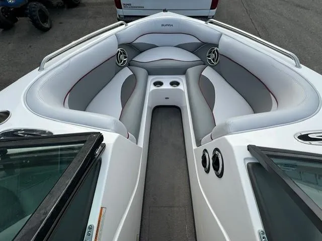 Slide: The Image of 2011 Supra 22v boat interior with white and gray seating, cup holders, and speakers. - 16
