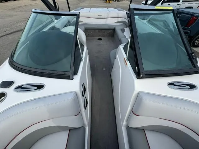 Slide: The Image of 2011 Supra 22v boat interior with dual windshields and white seating. - 5