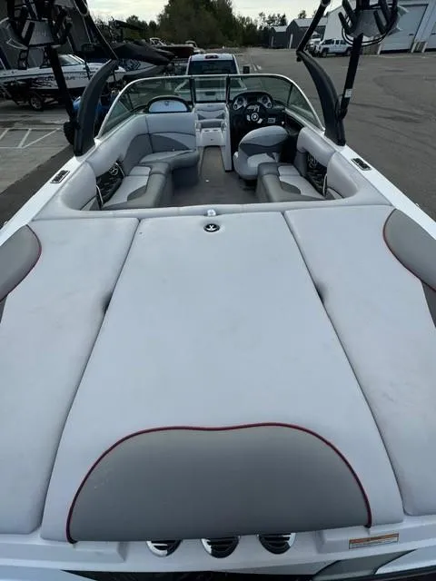 Slide: The Image of 2011 Supra 22v boat interior with gray seating and open deck layout. - 9