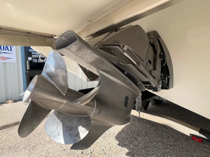 Slide: The Image of Close-up of a 2016 Cobalt R30 boat propeller and outdrive in a garage setting. - 10