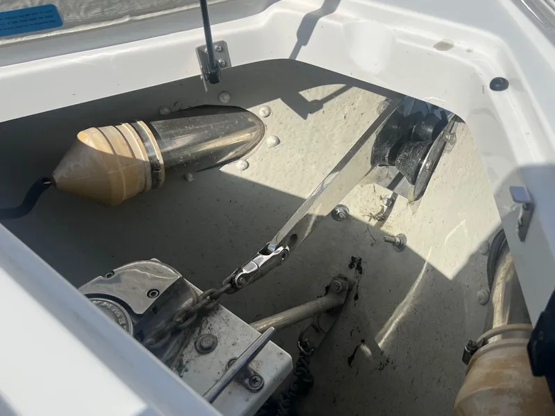 Slide: The Image of 2016 Cobalt R30 boat anchor compartment with chain and pulley system. - 13