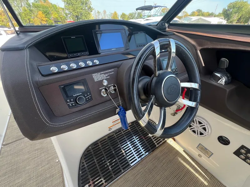 Slide: The Image of Steering console of a 2016 Cobalt R30 boat with modern controls and displays. - 17