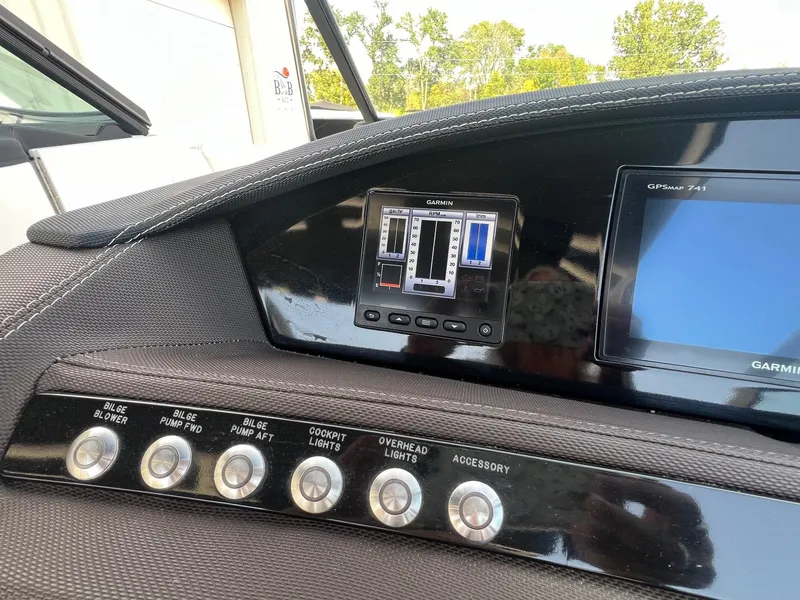 Slide: The Image of Dashboard of a 2016 Cobalt R30 boat with Garmin GPS and control buttons. - 18
