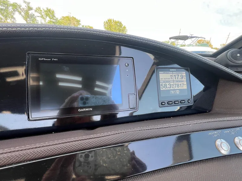 Slide: The Image of Dashboard of a 2016 Cobalt R30 boat featuring Garmin GPS and display screens. - 19