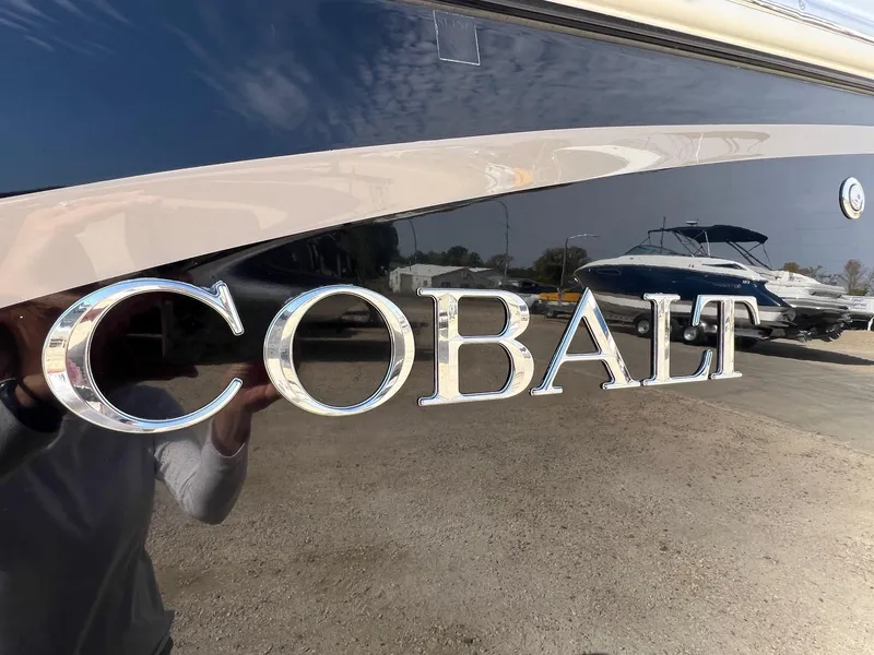Slide: The Image of 2016 Cobalt R30 boat with reflective chrome lettering on the hull. - 2
