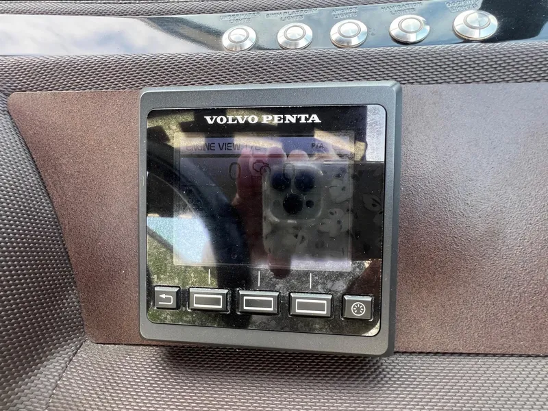 Slide: The Image of Volvo Penta display on 2016 Cobalt R30 boat dashboard with control buttons. - 22