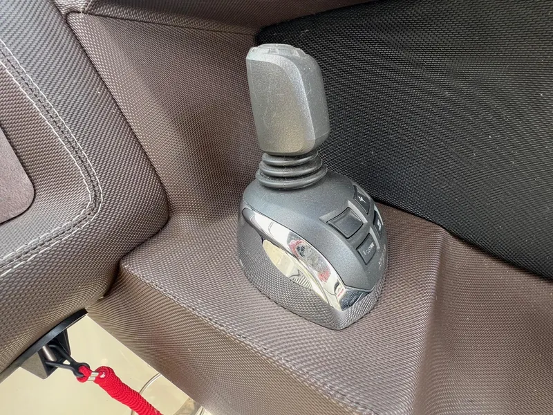 Slide: The Image of Joystick control in a 2016 Cobalt R30 boat, featuring textured upholstery. - 23