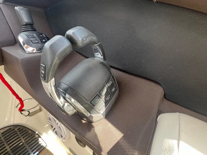 Slide: The Image of Throttle controls of a 2016 Cobalt R30 boat, featuring ergonomic design and buttons. - 24