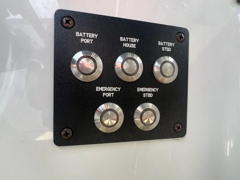Slide: The Image of Control panel with battery and emergency buttons on a 2016 Cobalt R30 boat. - 25