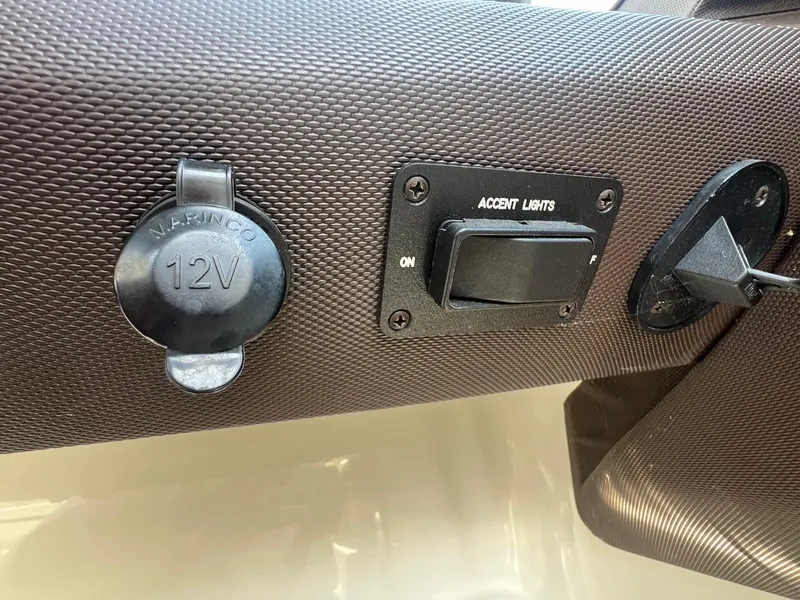 Slide: The Image of 12V outlet and accent light switch on 2016 Cobalt R30 dashboard. - 28