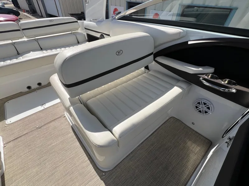 Slide: The Image of 2016 Cobalt R30 boat interior with white leather seating and cup holders. - 30