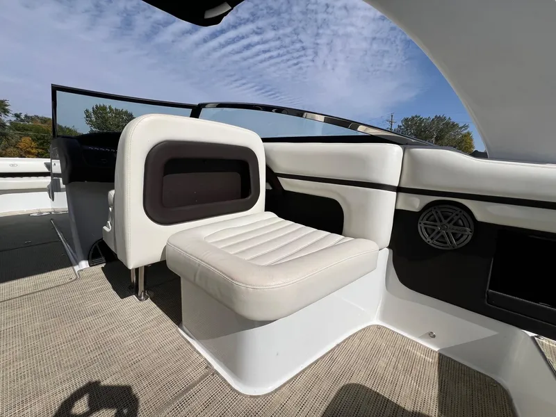 Slide: The Image of 2016 Cobalt R30 boat interior with white seating and speaker, under a blue sky. - 34