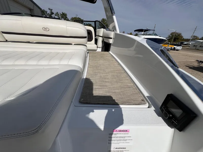 Slide: The Image of 2016 Cobalt R30 boat interior with white seating and control panel. - 38