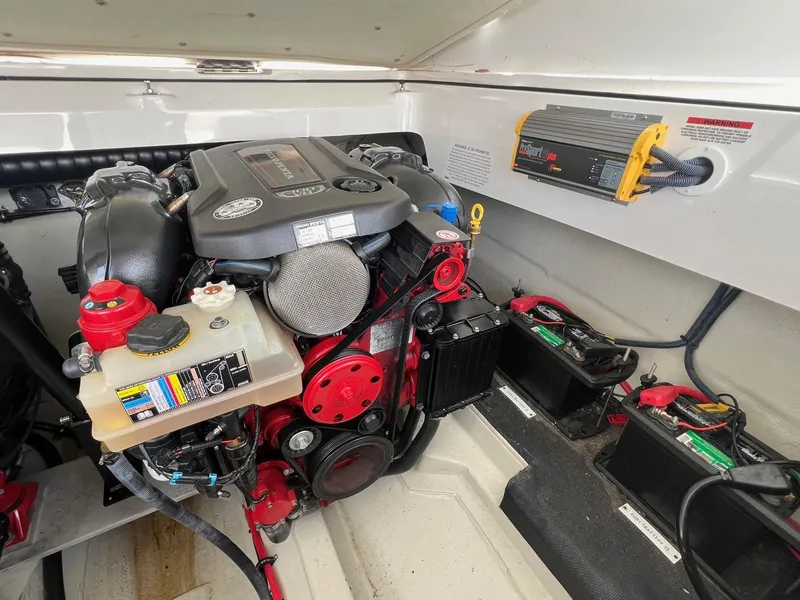 Slide: The Image of Engine compartment of a 2016 Cobalt R30 boat, featuring a well-maintained motor and battery setup. - 41