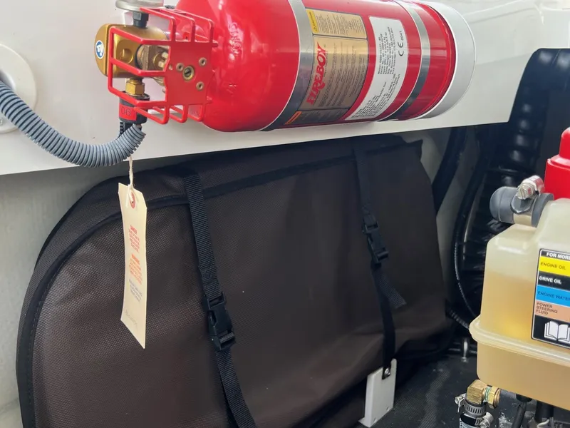 Slide: The Image of Fire extinguisher and equipment in 2016 Cobalt R30 boat engine compartment. - 46