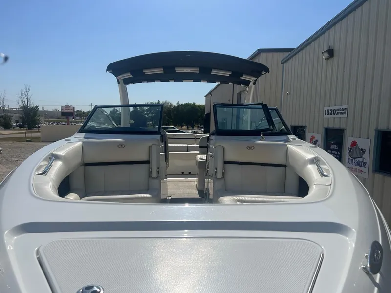 Slide: The Image of 2016 Cobalt R30 boat with white seating, parked near a building. - 6