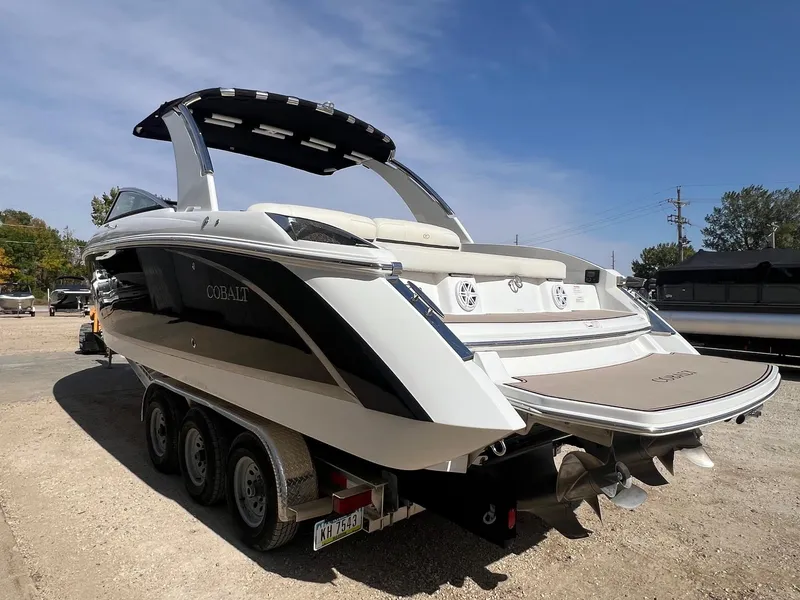 Slide: The Image of 2016 Cobalt R30 boat on trailer, sleek design, dual propellers, sunny day. - 7
