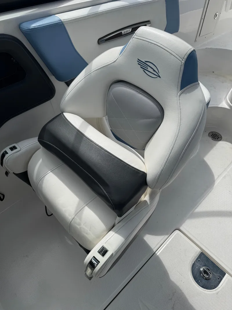 Slide: The Image of Luxury seating on 2022 Chaparral 267 SSX OB boat, featuring white and blue upholstery. - 10