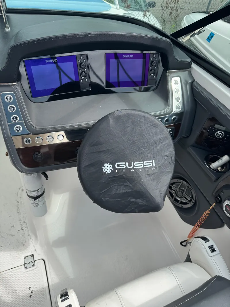 Slide: The Image of 2022 Chaparral 267 SSX OB boat dashboard with dual Simrad displays and Gussi Italia steering cover. - 12