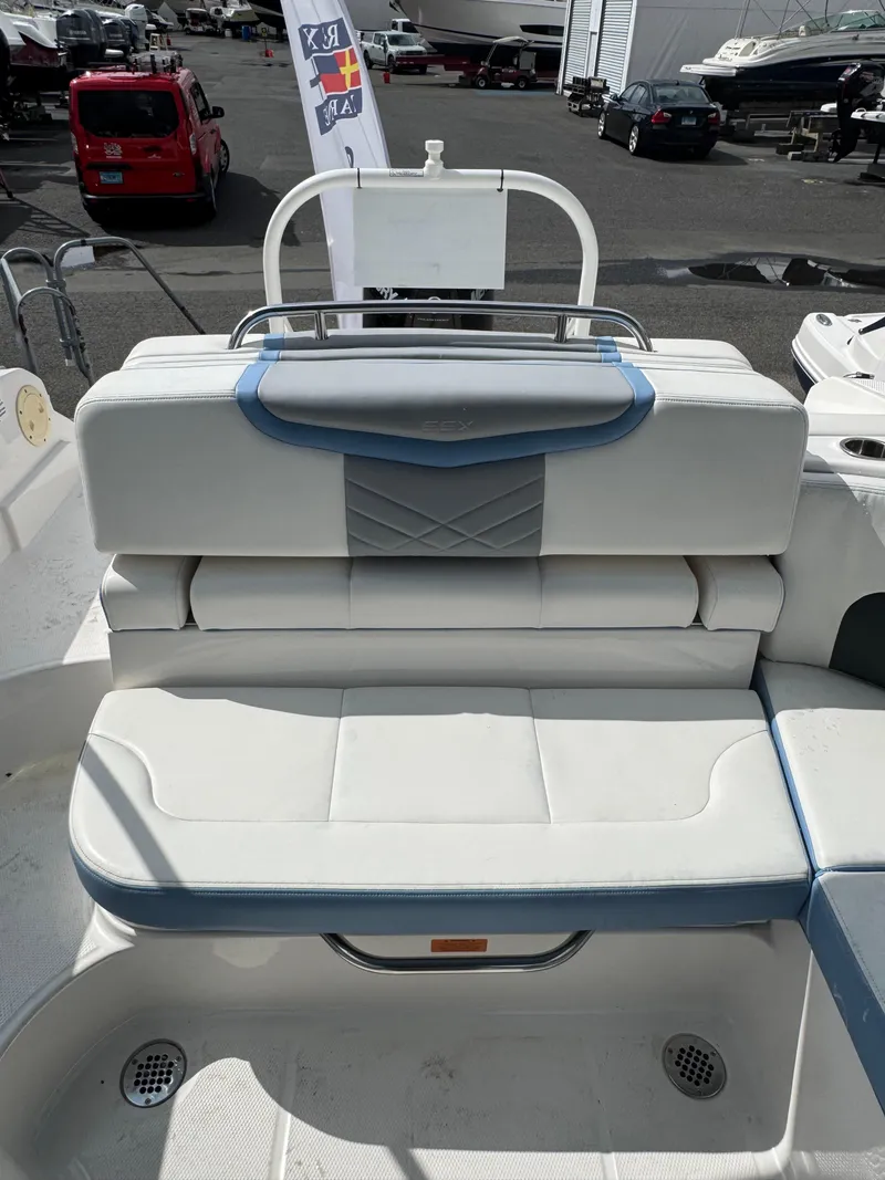 Slide: The Image of 2022 Chaparral 267 SSX OB boat seating area with white and blue upholstery. - 16