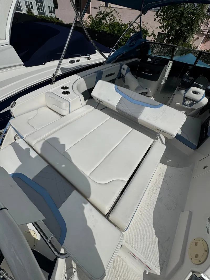 Slide: The Image of 2022 Chaparral 267 SSX OB boat interior with white seating and cup holders. - 18