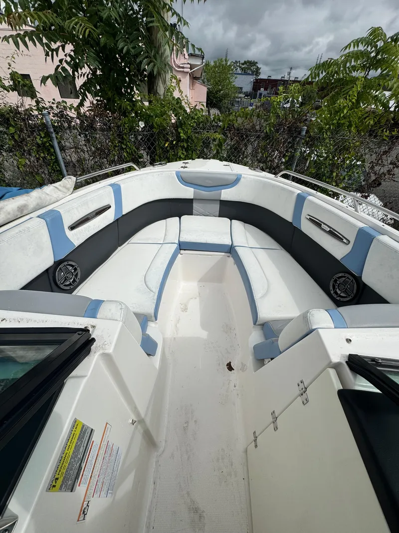 Slide: The Image of 2022 Chaparral 267 SSX OB boat interior with cushioned seating and speakers. - 23