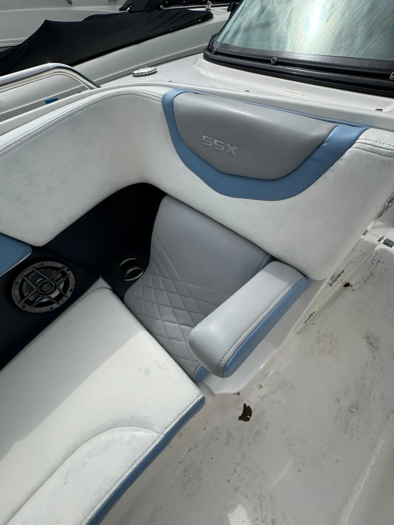 Slide: The Image of 2022 Chaparral 267 SSX OB boat interior with white and blue seating. - 26